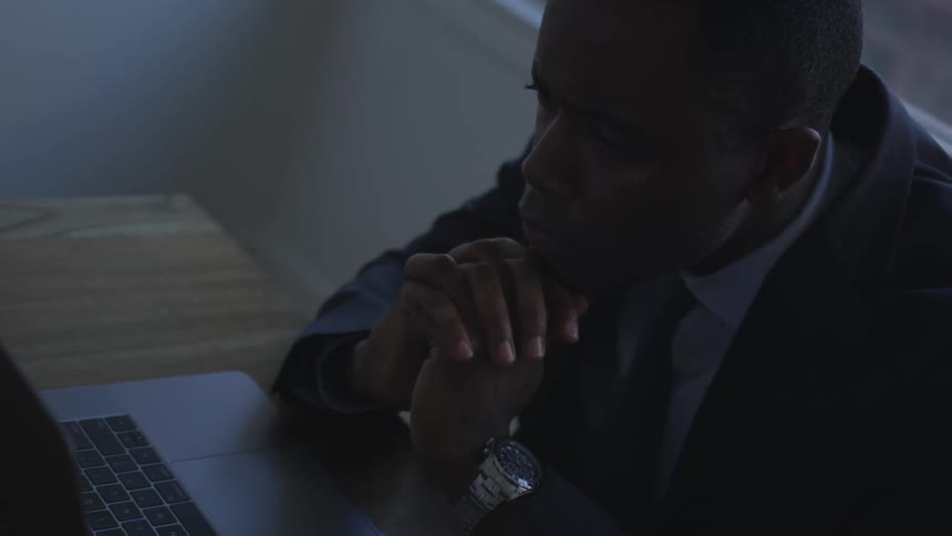 A businessman works on a laptop