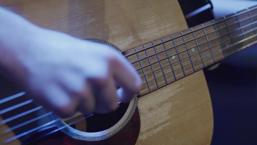 A guitarist is playing a guitar onstage
