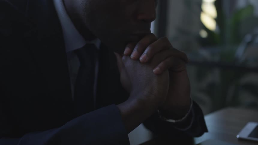 A businessman is deep in thought at a desk