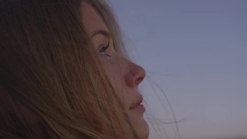 A woman is looking up at the sky
