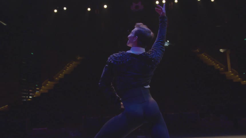 A man is posing on the stage