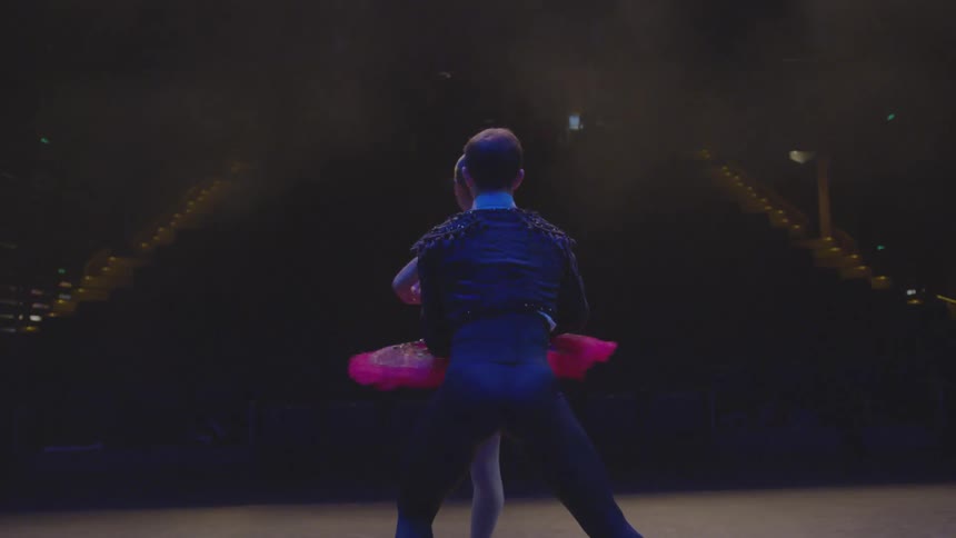 A male and female ballet dancer perform on stage