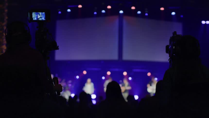 An audience watches a band perform on stage