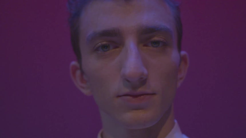 A man turns his head and stares straight ahead