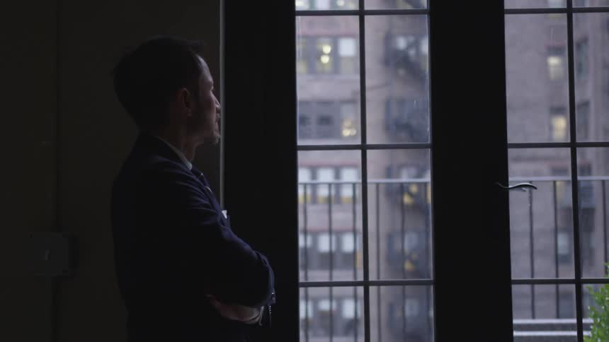 A businessman looks out a window