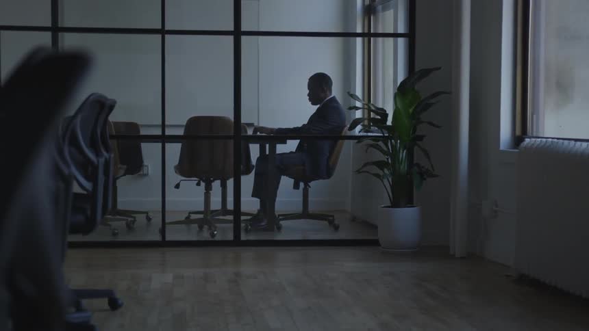 A businessman works in a conference room