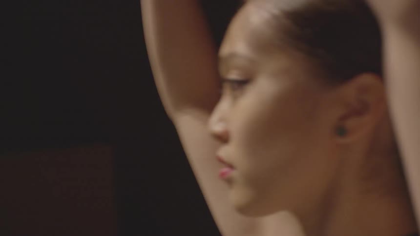 A woman is dancing moving her arms around