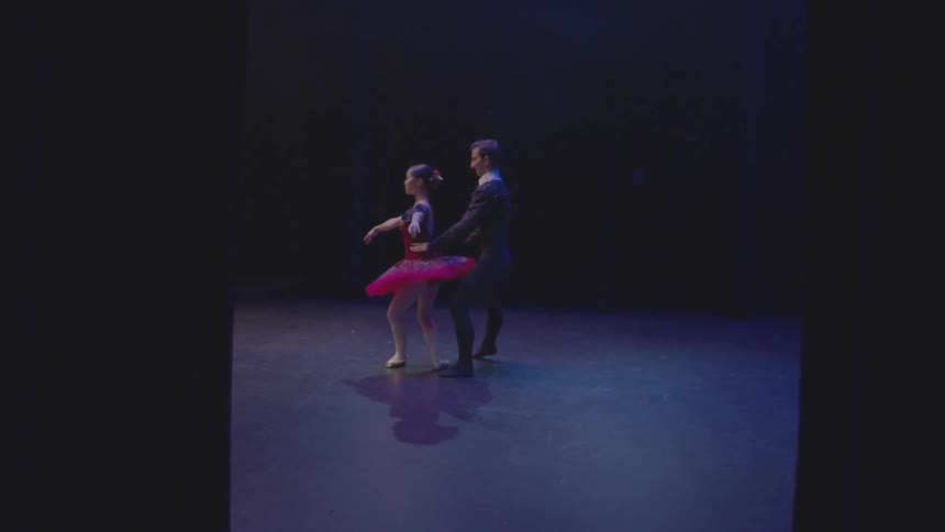 A male and female ballet dancer perform on stage
