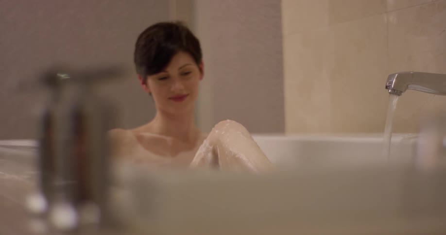 A woman is taking a nice bubble bath