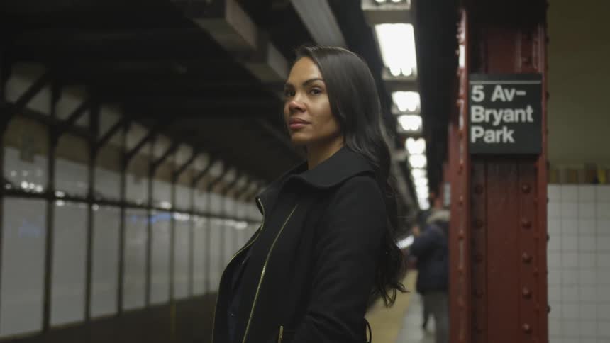 A woman waits patiently for the train