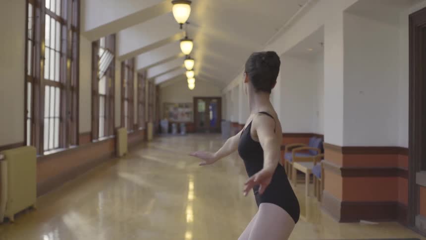 A ballerina twirls down the hallway