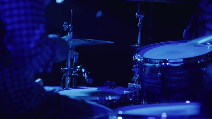 A drummer plays on stage