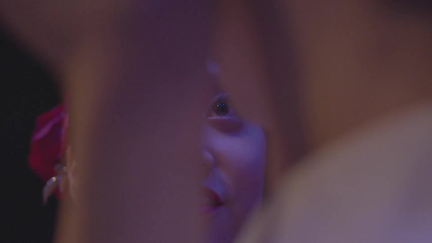 A woman looks up smiling to another person
