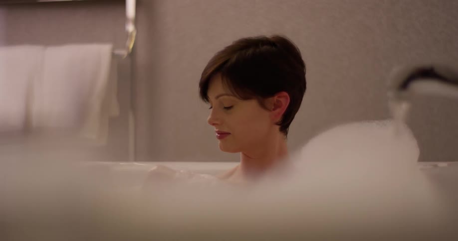 A woman is taking a bubble bath