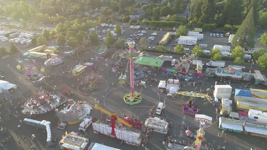 The carnival is very busy with many rides and people
