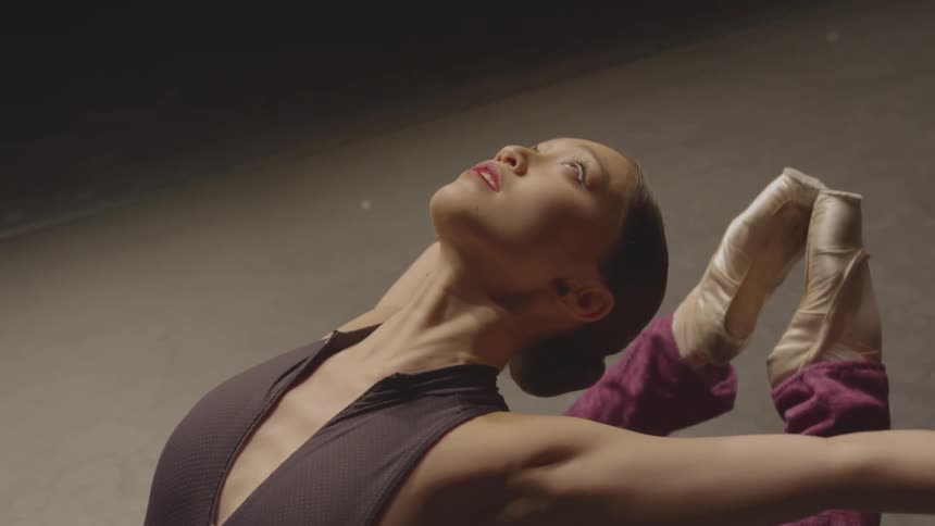 A woman stretches back her arms and legs