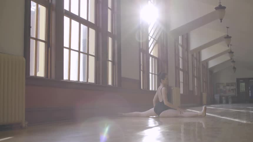 A woman does a split in the hallway