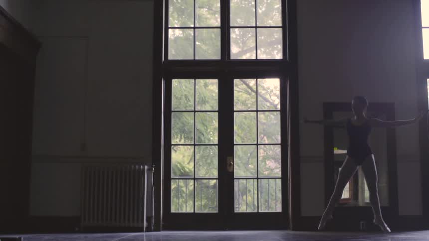 A dancer jumps through the room