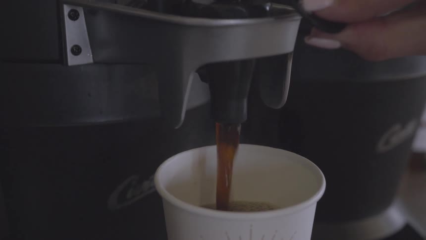 The person fills the cup with coffee
