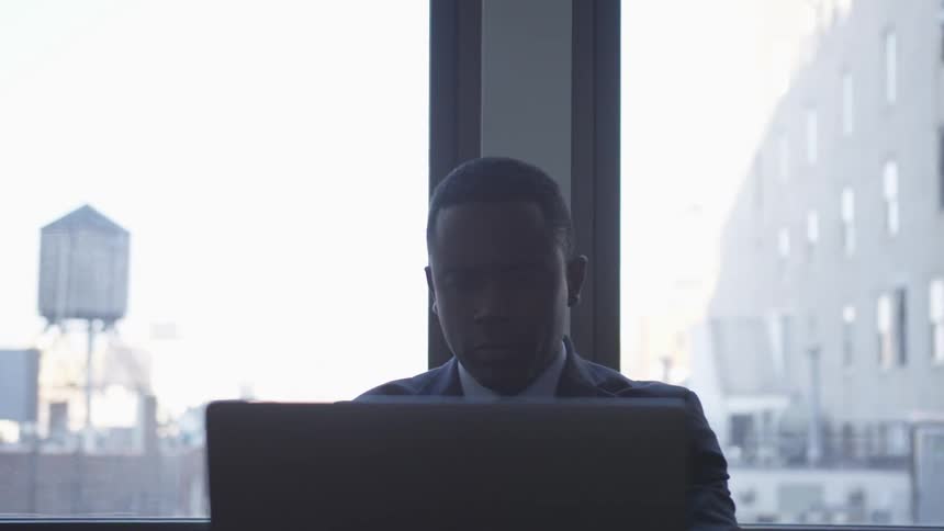 A businessman works on a laptop