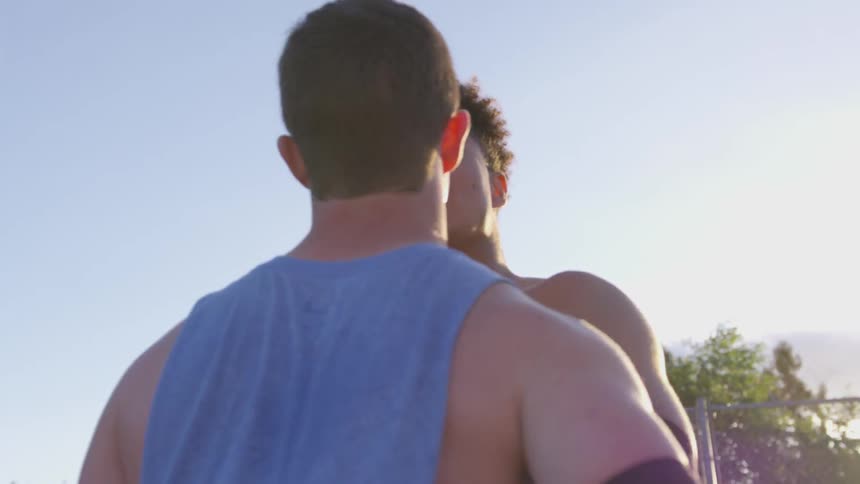Two athletes get into an argument on an outdoor athletic field