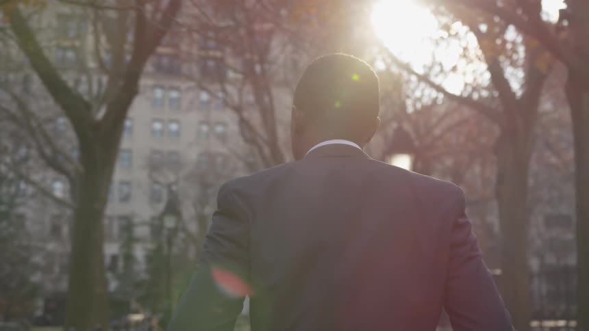 The man in the suit walks in the city