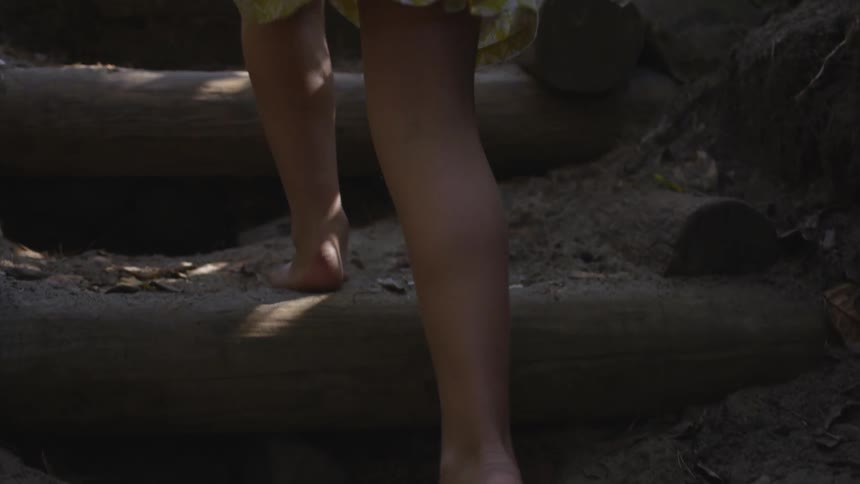 Brother And Sister Walking Barefoot On A Trail