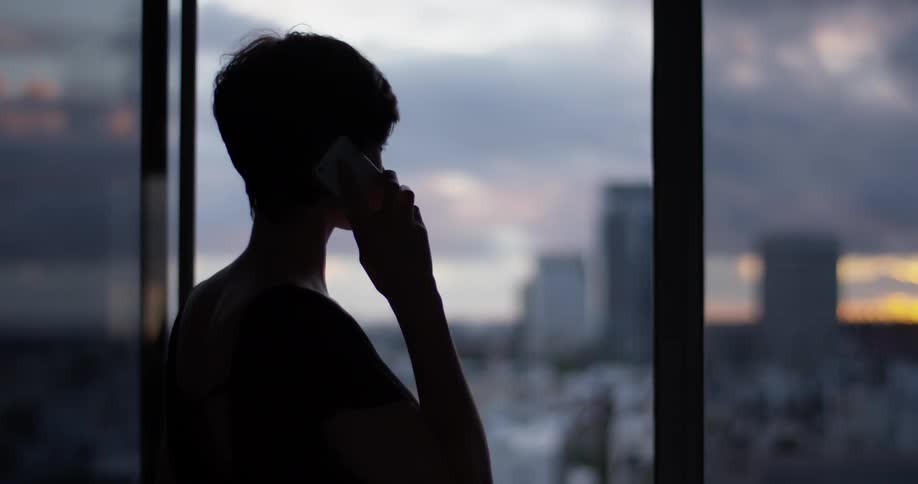A woman talks on a phone in a las vegas hotel room
