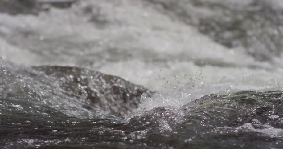 The water splashes and swirls in the stream