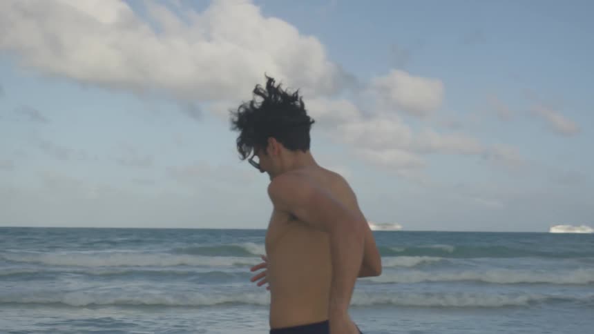 A man runs on the beach