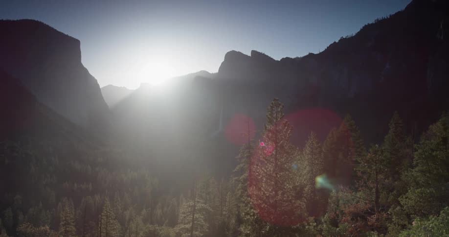 The sun is slowly rising behind the mountain