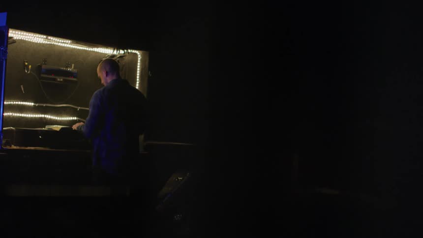 The man is working on something on his bench
