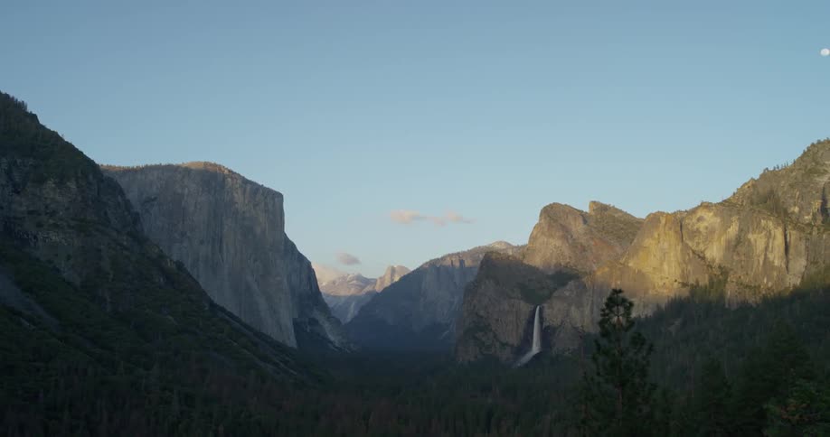 Sets over tall rocky mountains