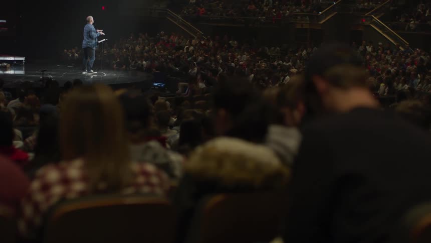 People watch as musicians perform on stage
