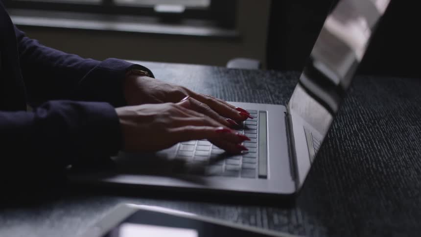 A person is typing on the laptop