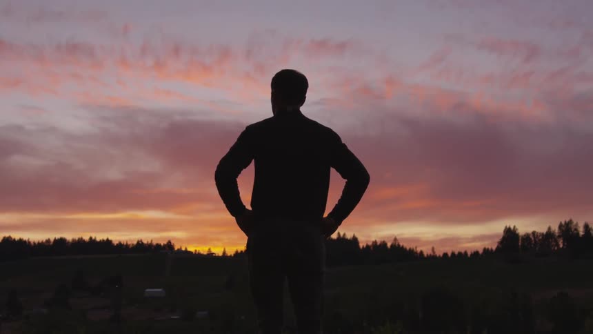 A man is in the shadows at dawn