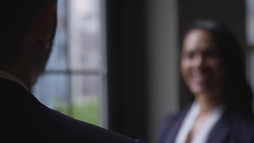 A man talks with a woman in the office