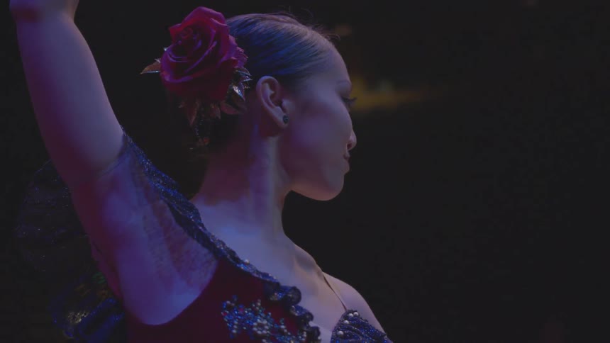 The woman is dancing on stage