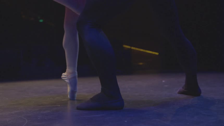 A male and female dancer perform on a stage