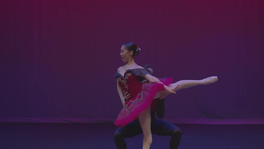 A woman is lifted up as she does a dance performance