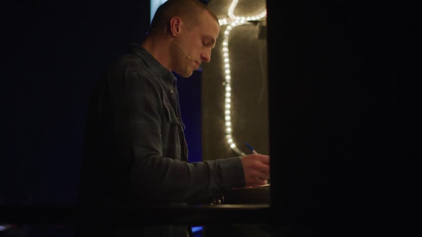 A man is signing something at night