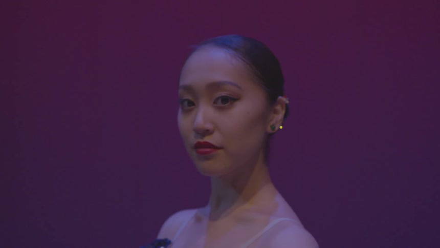 A ballerina is wearing a costume and makeup