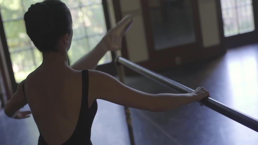 A woman is leaning practicing dancing