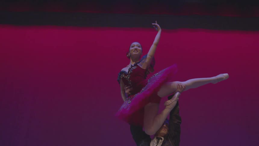 A male and female ballet dancer perform on stage