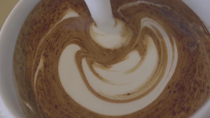 Cream is poured into the mug