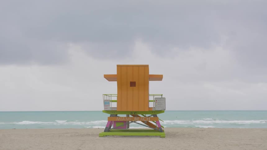 Clouds are hanging over a lifeguard tower at a beach on a stormy day