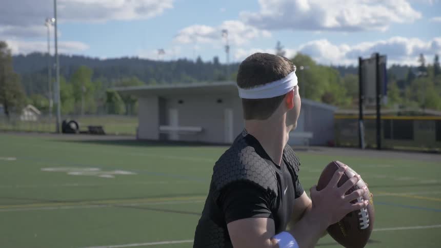 Men play football on an outdoor field