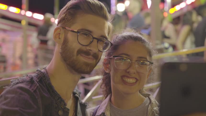 A man and woman have fun at the carnival