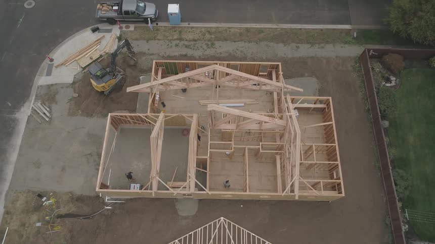Workers are busy at a construction project in the suburbs in daylight