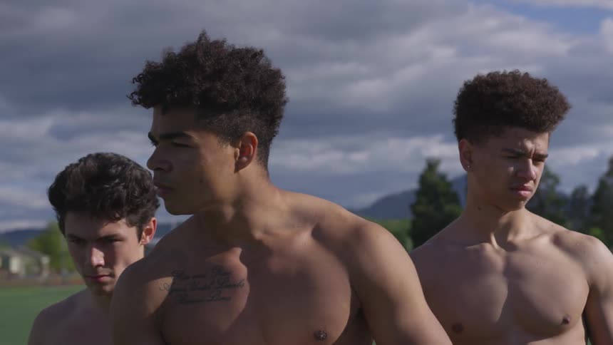 A group of men flex on the field